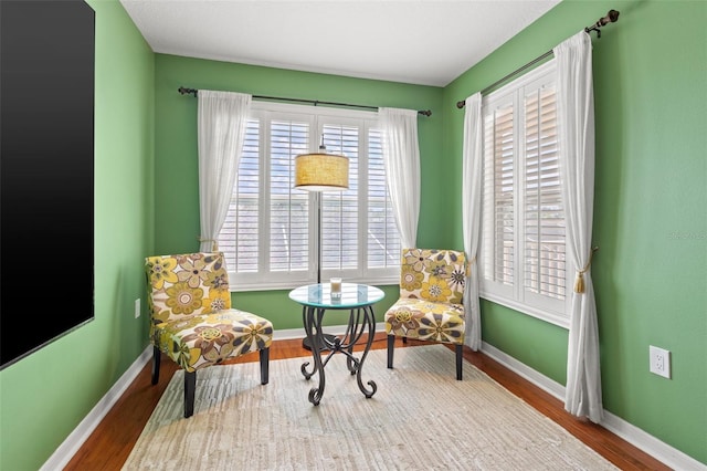 sitting room with wood-type flooring