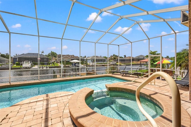 view of pool featuring an in ground hot tub and a lanai