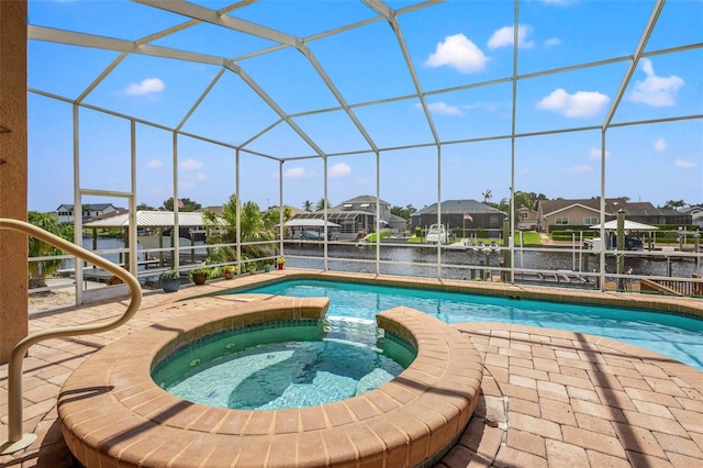 view of swimming pool featuring glass enclosure and an in ground hot tub