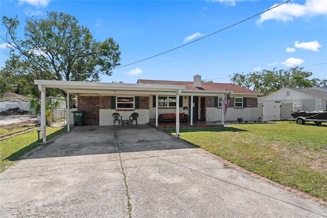 single story home featuring a carport and a front lawn