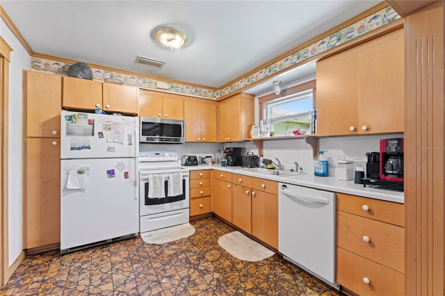 kitchen featuring white appliances, dark tile patterned floors, and sink