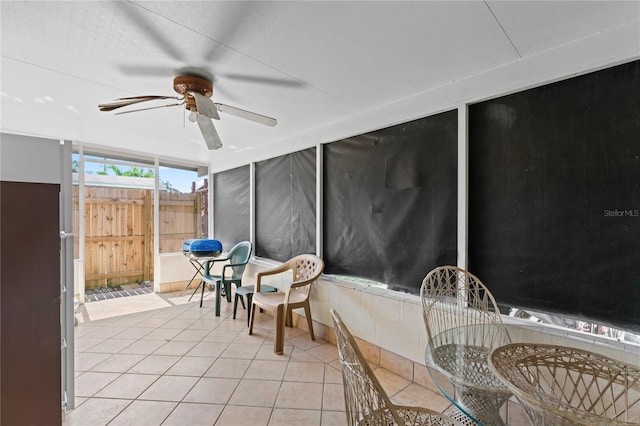 sunroom / solarium featuring ceiling fan