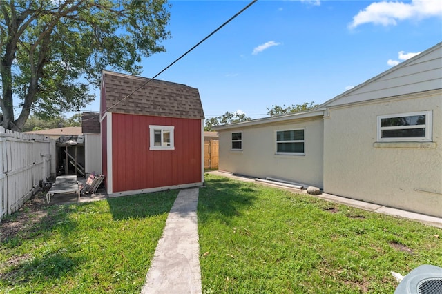 view of yard with cooling unit and a storage shed