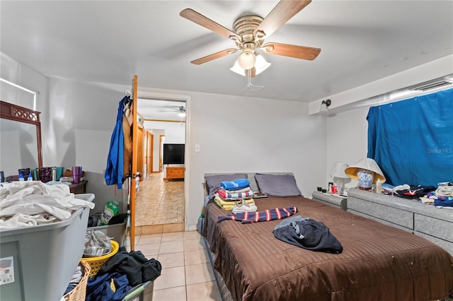 tiled bedroom featuring ceiling fan