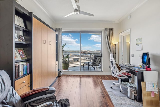 office area with ornamental molding, ceiling fan, baseboards, and wood finished floors