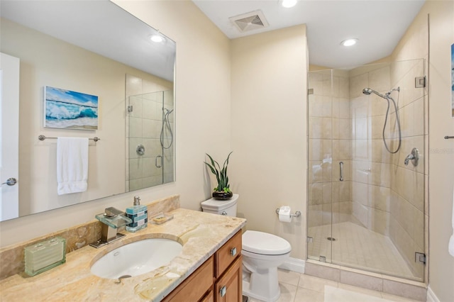 bathroom featuring tile patterned flooring, vanity, toilet, and walk in shower