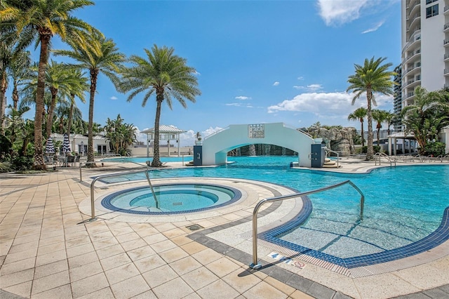 view of swimming pool with a community hot tub and a patio