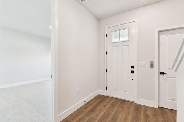 foyer entrance with baseboards and wood finished floors