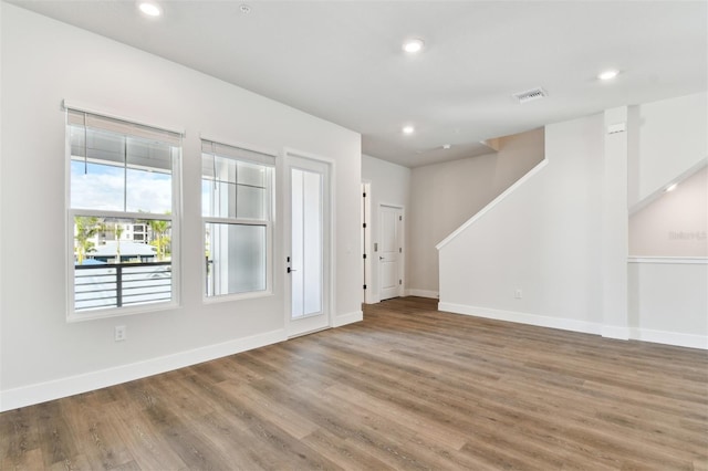 interior space featuring visible vents, recessed lighting, baseboards, and wood finished floors