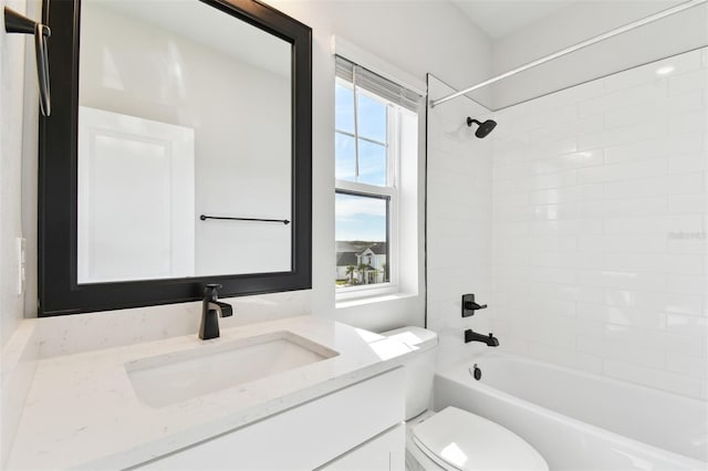 bathroom featuring toilet, shower / washtub combination, and vanity