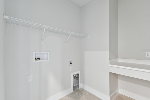 washroom featuring baseboards, light tile patterned floors, laundry area, hookup for a washing machine, and electric dryer hookup