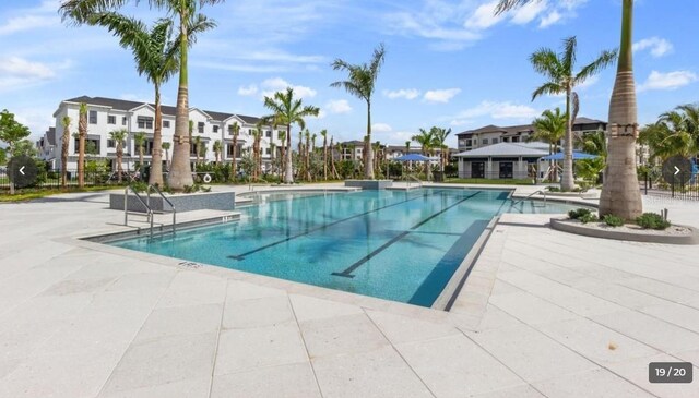 pool featuring a patio area and a residential view