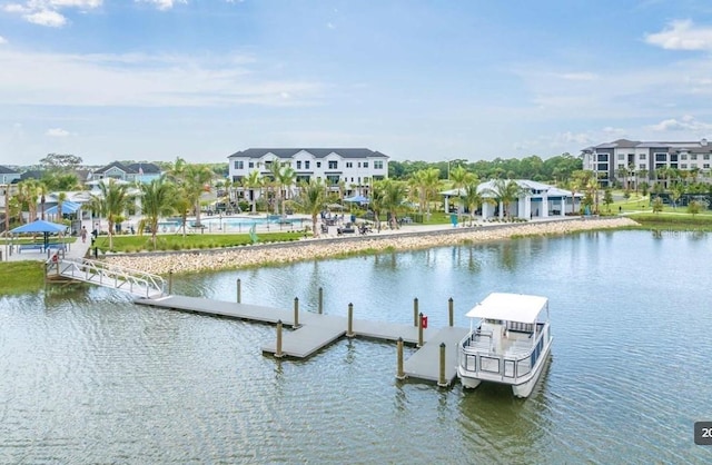 exterior space with a residential view, a community pool, and a water view