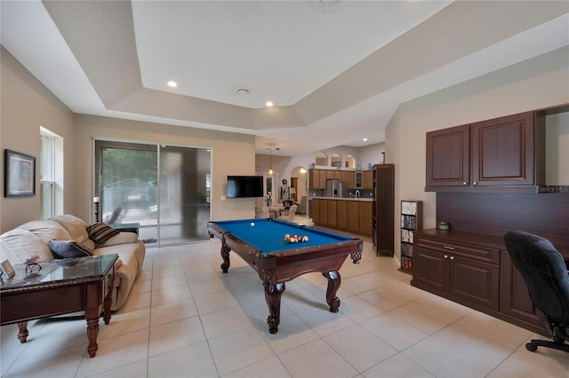 rec room featuring light tile patterned flooring, a tray ceiling, and billiards