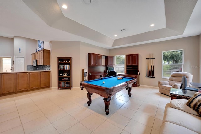 game room featuring pool table, light tile patterned floors, and a tray ceiling