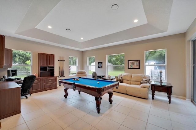 game room with a raised ceiling, pool table, plenty of natural light, and light tile patterned floors