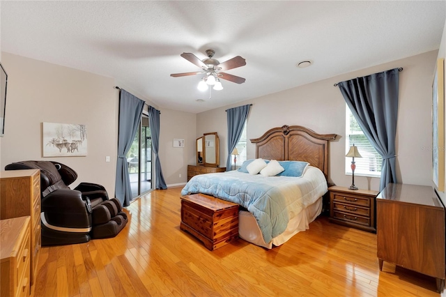 bedroom featuring access to exterior, light hardwood / wood-style flooring, and ceiling fan