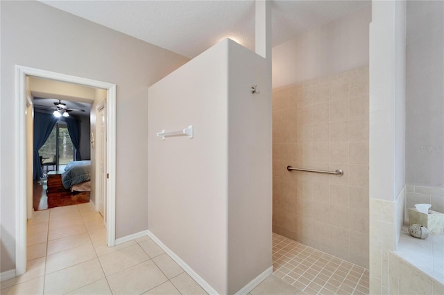 bathroom featuring a textured ceiling, tile patterned floors, and ceiling fan