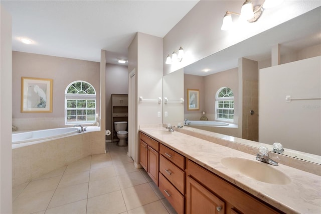 bathroom with tile patterned floors, tiled bath, double vanity, and toilet