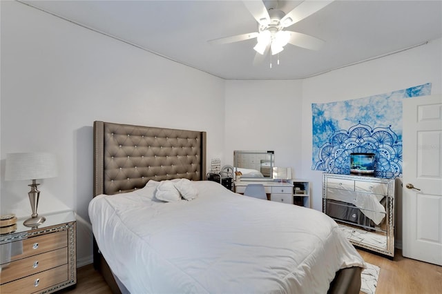 bedroom with ceiling fan and hardwood / wood-style flooring