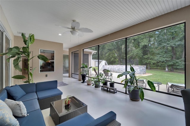 sunroom / solarium with ceiling fan and a healthy amount of sunlight