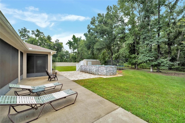 view of yard with a storage shed, a patio, and a trampoline