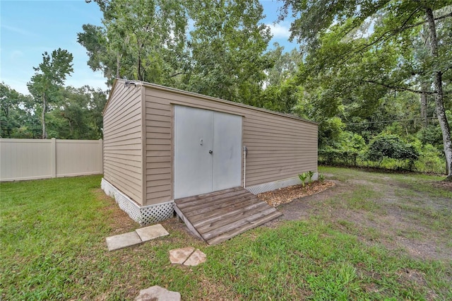 view of outbuilding featuring a lawn