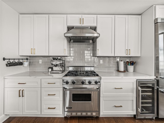 kitchen with wine cooler, dark wood-type flooring, light stone counters, and luxury stove