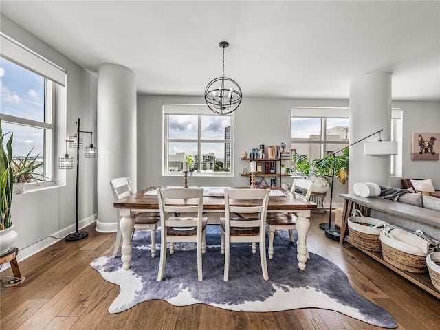 dining space with a wealth of natural light, a chandelier, and hardwood / wood-style flooring