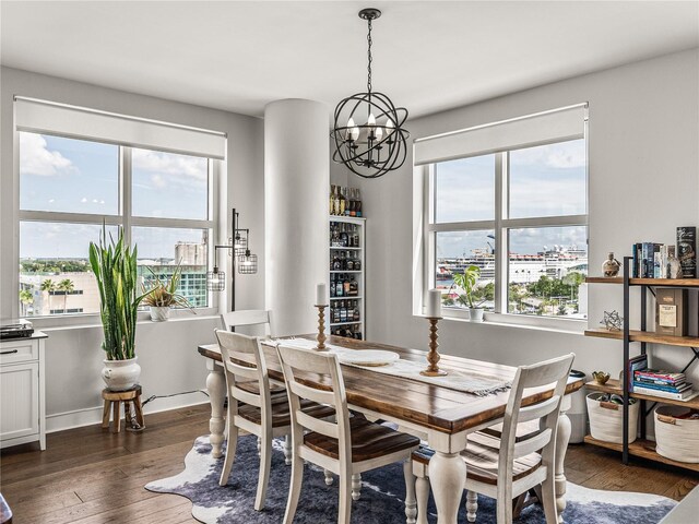 dining space featuring plenty of natural light, an inviting chandelier, and dark wood-type flooring