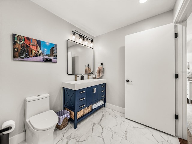 bathroom featuring tile patterned flooring, vanity, and toilet