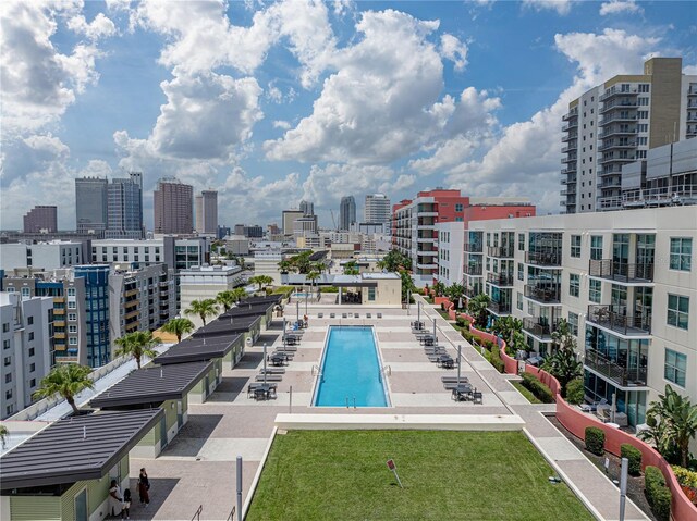 view of swimming pool with a lawn