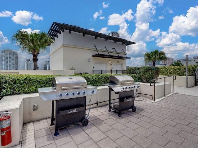 view of patio / terrace featuring exterior kitchen and a grill