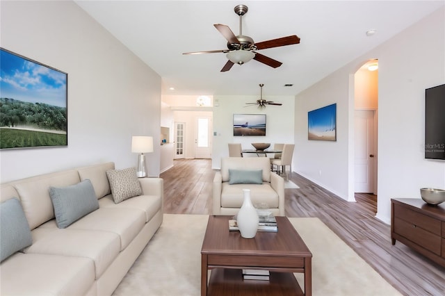 living room featuring ceiling fan and hardwood / wood-style flooring