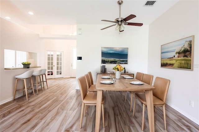 dining room featuring ceiling fan, french doors, and light hardwood / wood-style floors