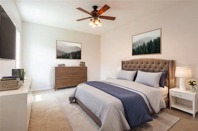 bedroom with ceiling fan and light carpet