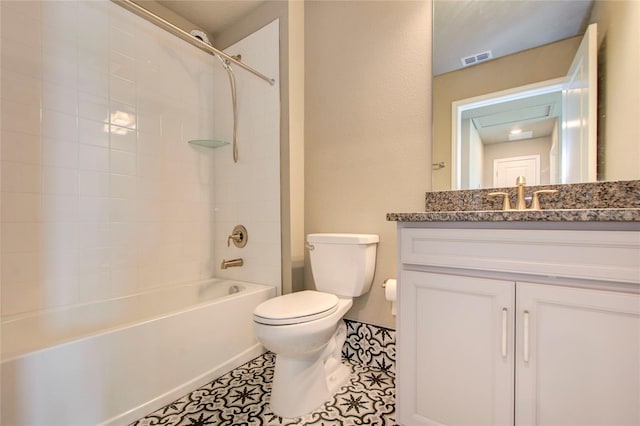 full bathroom featuring tile patterned flooring, tiled shower / bath, vanity, and toilet