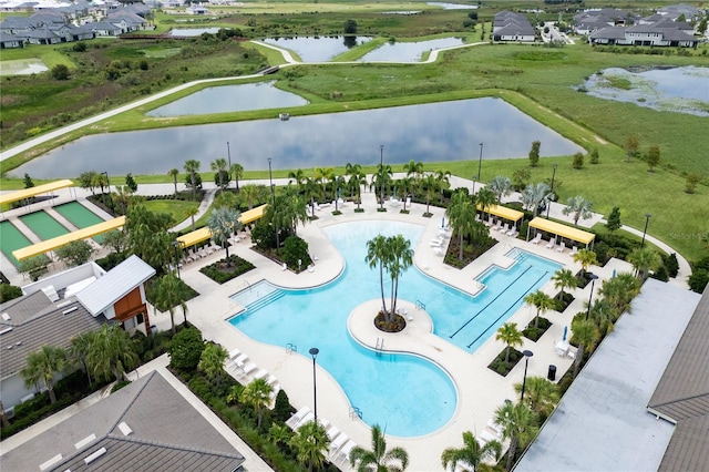 view of swimming pool featuring a patio area and a water view