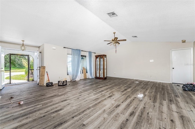 unfurnished living room featuring lofted ceiling, wood-type flooring, a textured ceiling, and ceiling fan