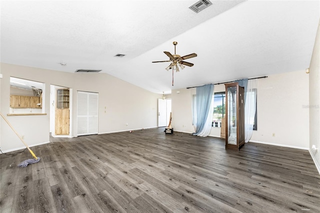 empty room with ceiling fan, wood-type flooring, and vaulted ceiling