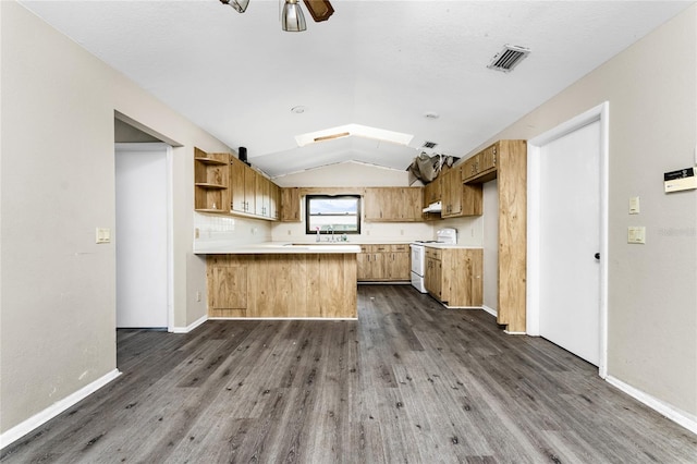 kitchen with dark hardwood / wood-style flooring, ceiling fan, kitchen peninsula, lofted ceiling with skylight, and electric range