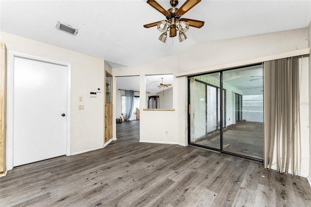 spare room featuring ceiling fan, lofted ceiling, and hardwood / wood-style floors