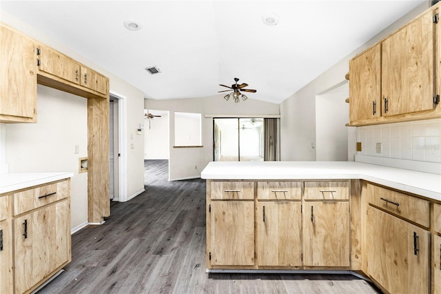 kitchen with lofted ceiling, ceiling fan, kitchen peninsula, dark wood-type flooring, and backsplash