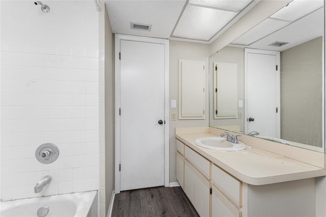 bathroom with  shower combination, wood-type flooring, and vanity