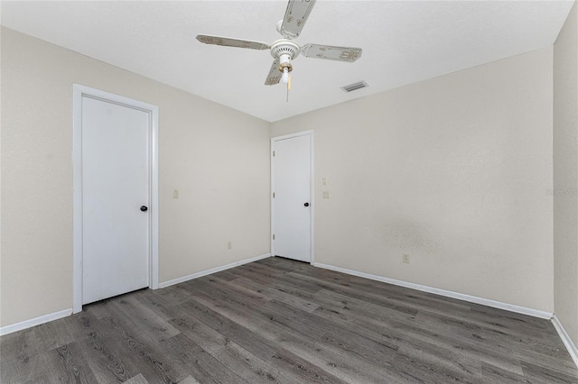 spare room with hardwood / wood-style floors and ceiling fan