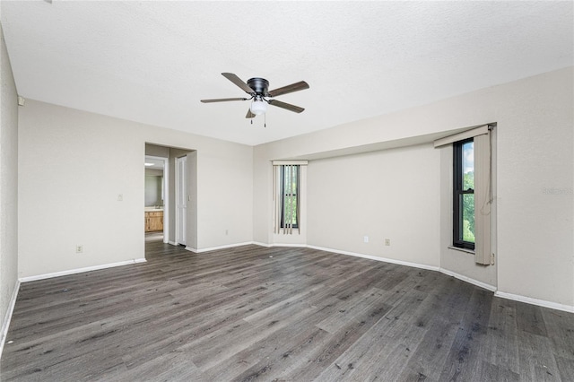 empty room featuring ceiling fan, plenty of natural light, and hardwood / wood-style flooring