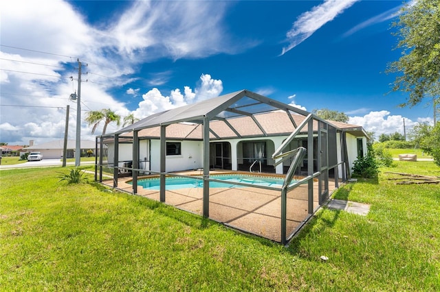 view of pool with a lanai, a patio, and a yard