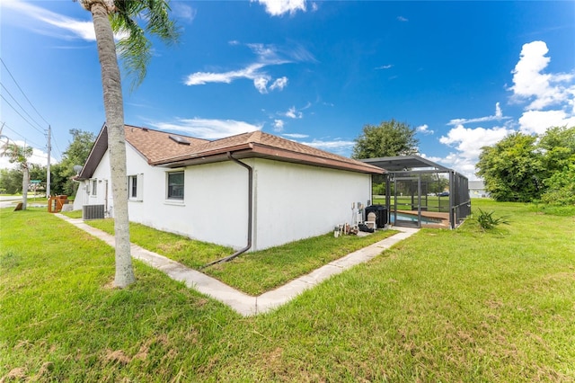 view of side of home featuring a lanai, a yard, a pool, and central air condition unit