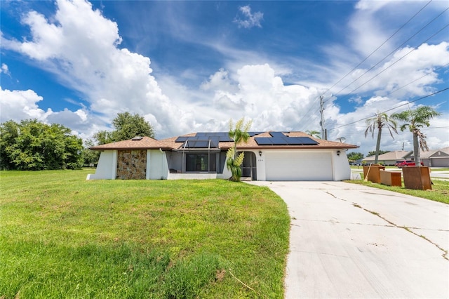 view of front of house featuring a front lawn, solar panels, and a garage