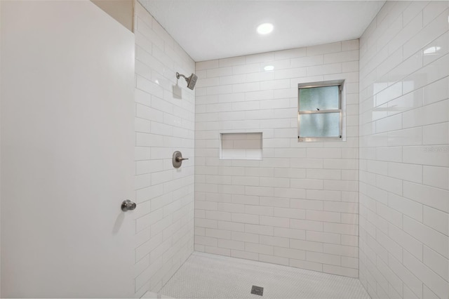 bathroom with tiled shower